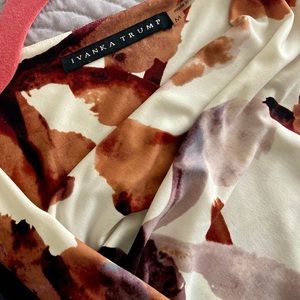 Eye catching shell with asymmetric neckline.